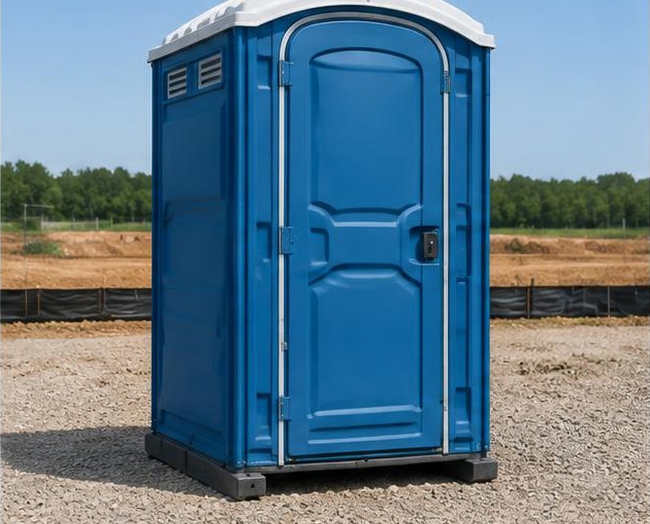 Blue portable chemical toilet at a construction site